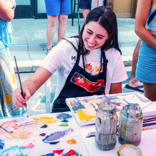 a young person enjoys art activities at Kimball Art Center