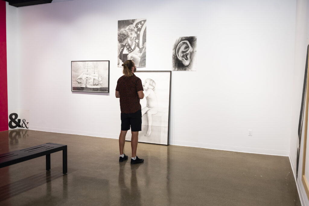 A person views artwork on display at Kimball Art Center