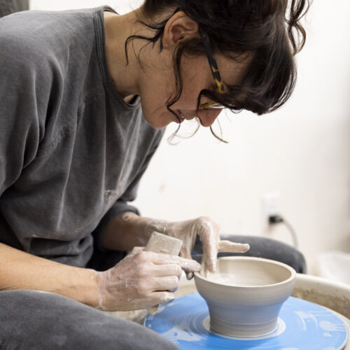 a person uses a pottery wheel to create ceramic art at a Kimball Art Center art workshop